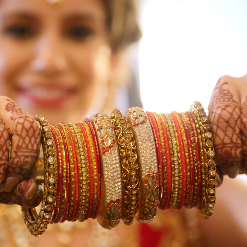 A bride looking at a set of bangles - Hablis Hotel, Chennai