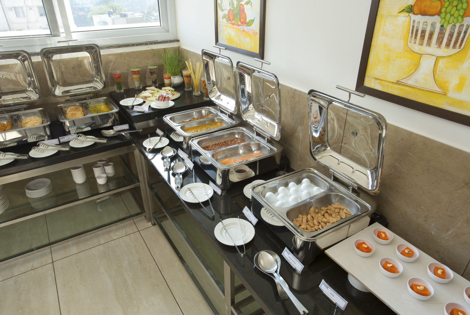 A hotel buffet station featuring a variety of hot dishes - De Venetian by TGI, Brookefield