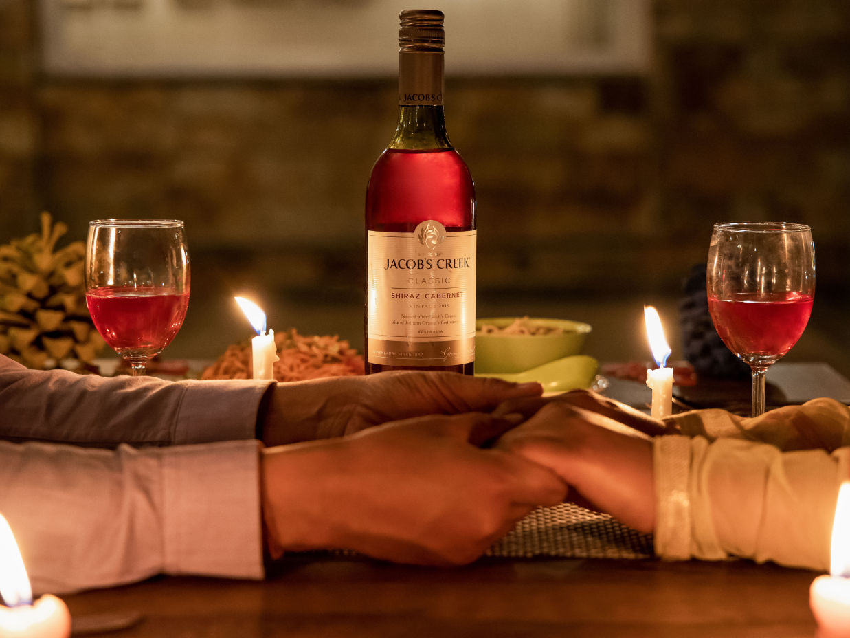 A couple holding hand while having candle light dinner - The Nature's Green Resort, Bhimtal