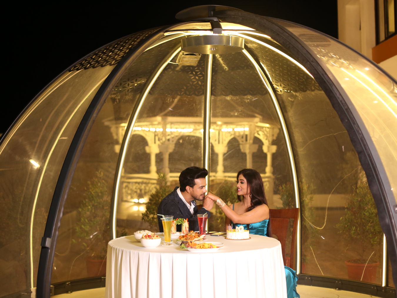 a bubble kind of dome with a table for two and couple inside celebrating - Shanti Seaview Resort & Spa