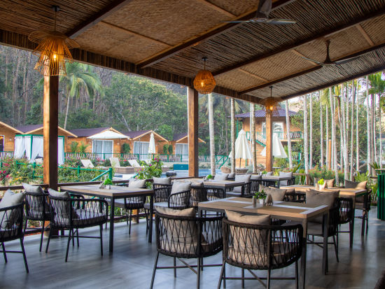 seating arrangements of the restaurant with al fresco dining option - Stone Wood Jungle Resort, Dandeli