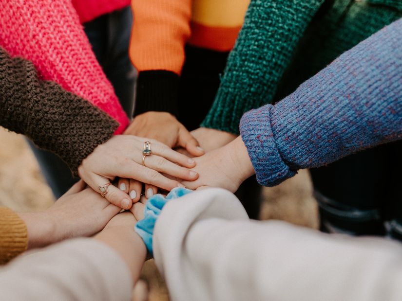 people joining hands together