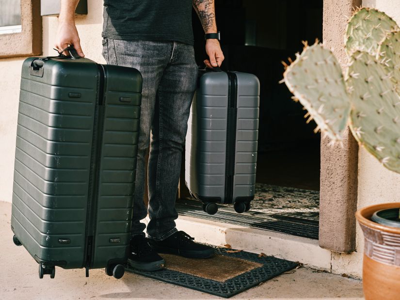 A person carrying 2 suitcases