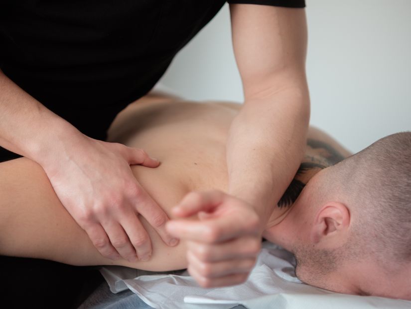 A Man getting a massage by a masseur - IOSIS Spa & Wellness