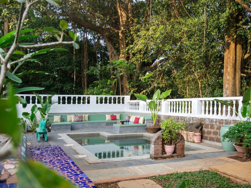 white fenced oool surrounded by greenery @ Lamrin Ucassaim Hotel, Goa