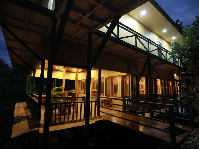 one of the cottages at The Sal Woods Forest Resort & Spa lit up at night