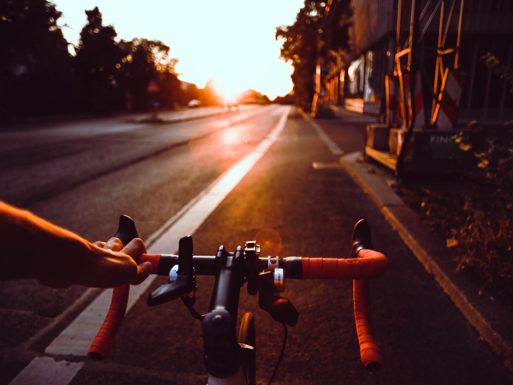 a person cycling early in the morning