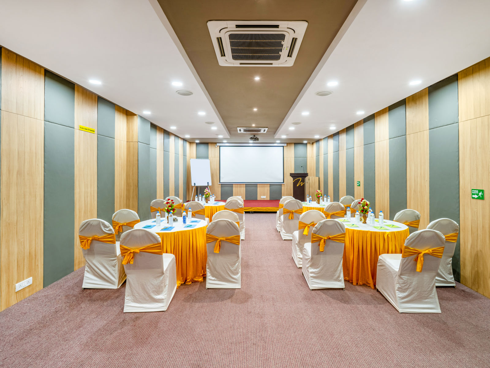 A high-tech conference room with a table and chairs at Westside Hotel Hitech City