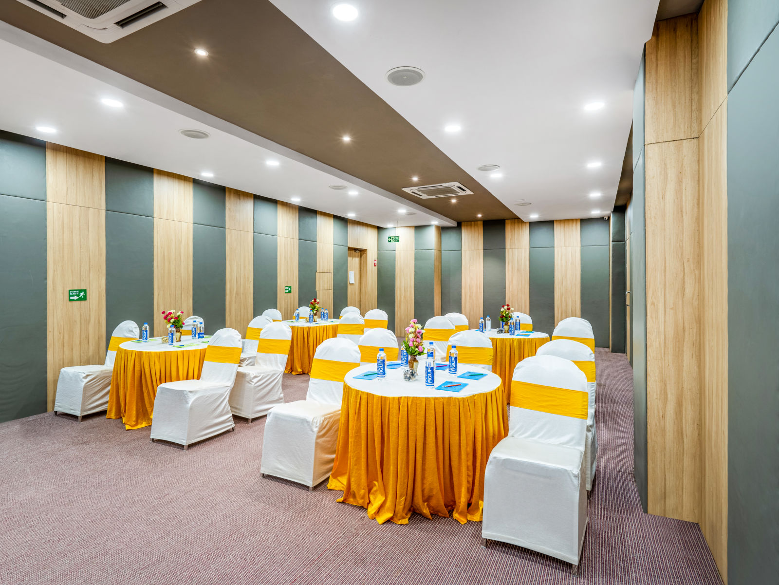 A well-furnished conference room displaying a table and chair at Westside Hotel Hitech City