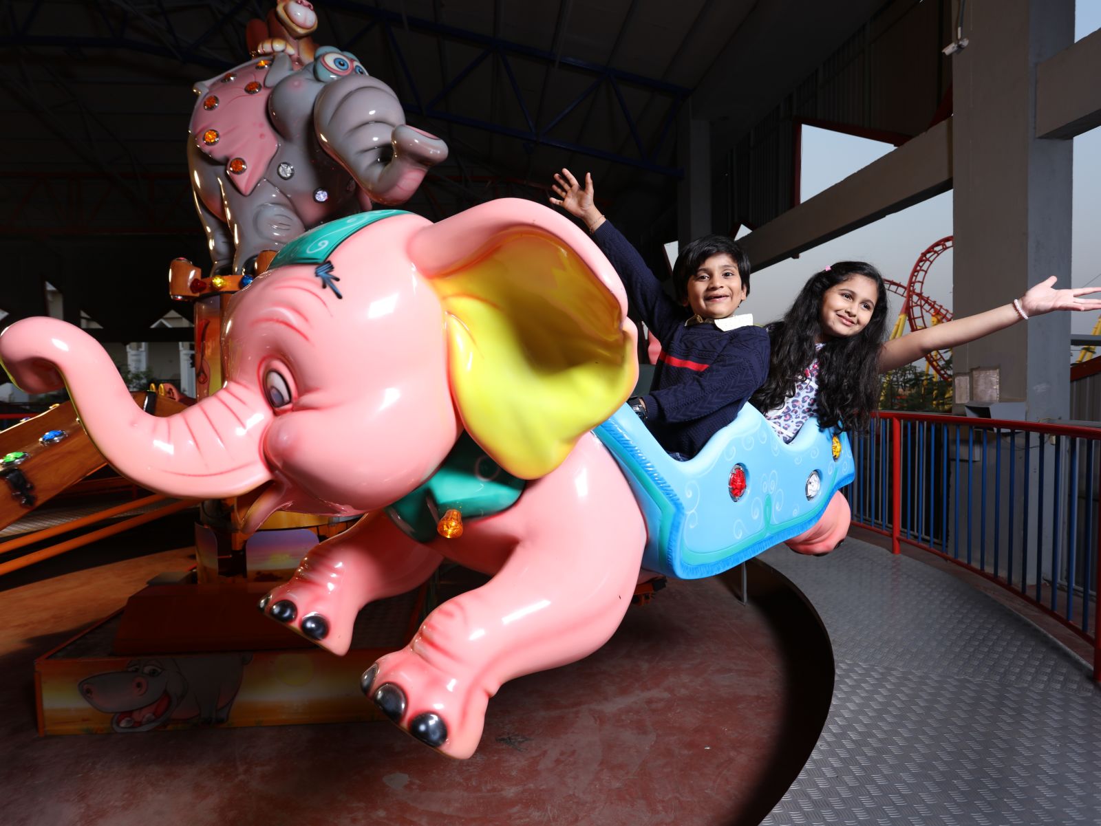 Kids enjoying a toy elephant ride