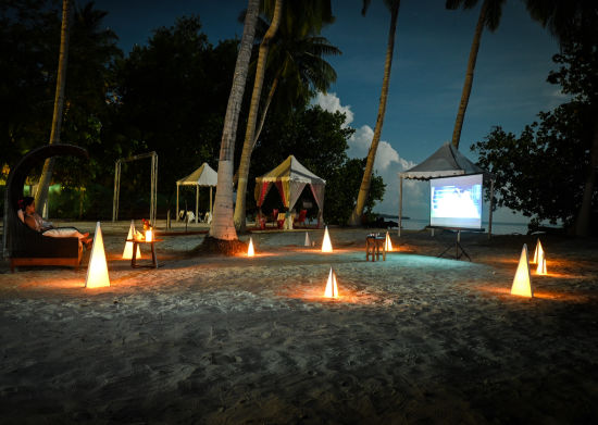 alt-text White screen with a movie showing on the beach 1 - Coral Reef Resort Havelock