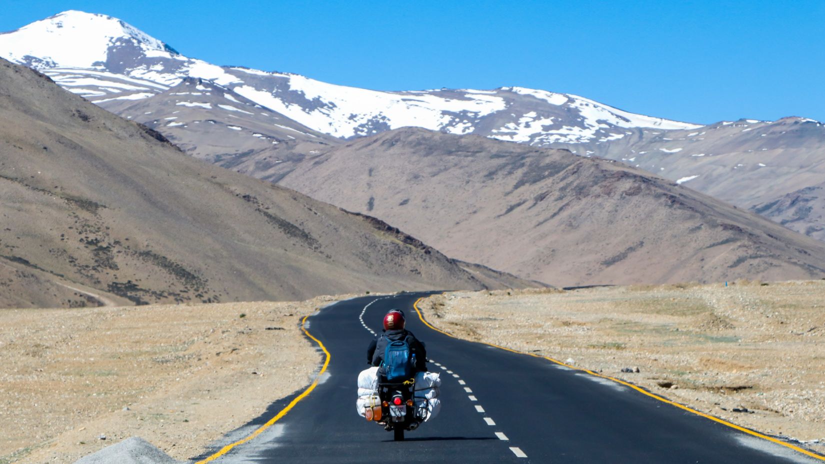 Man riding on the bike amidst the mountains