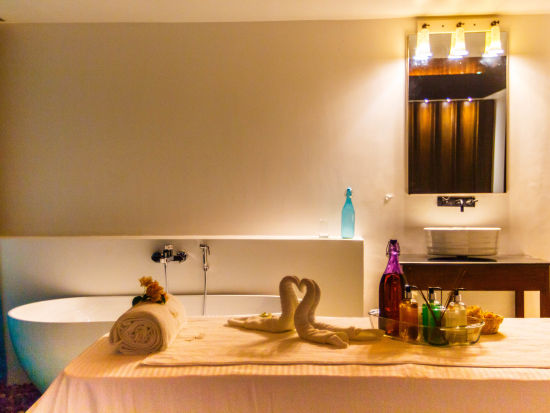 interior of a massage Spa in port Blair table with towel swans, towel roll and oil bottles placed on it - Symphony Samudra Beachside Jungle Resort And Spa, Port Blair