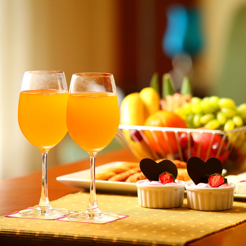 table of two drinks, fruits and desserts