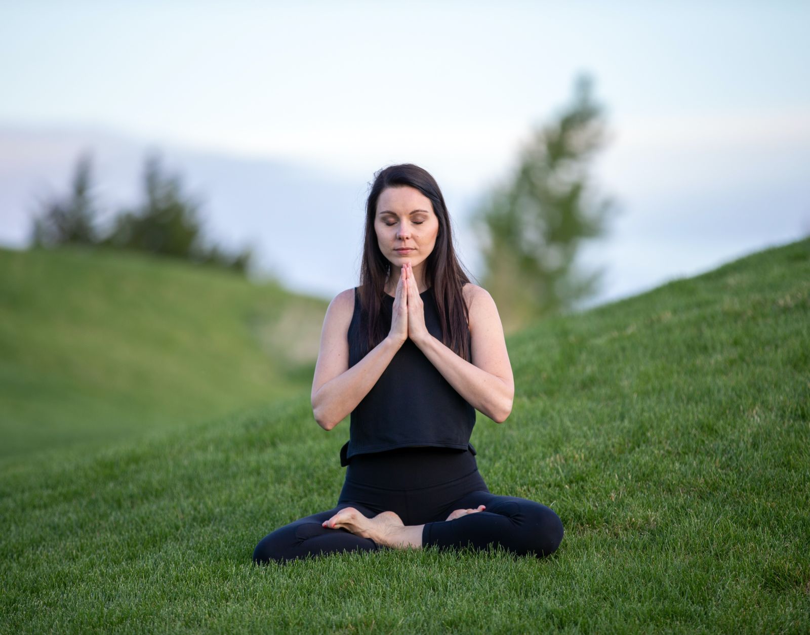 a woman doing yoga on carpeted lawn