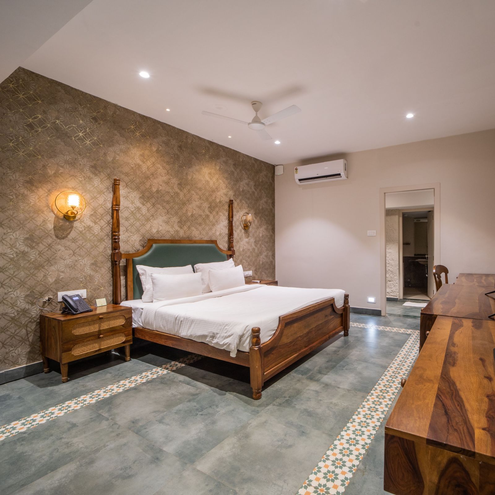 An image of a room with king size bed, TV, bed side table - Trance Veechika Resort, Vikarabad