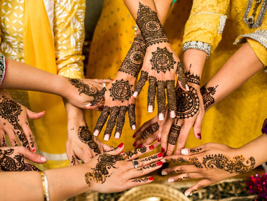 alt-text women showing their henna hands