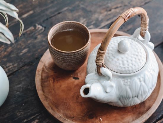 a plate serving hot tea and a teapot