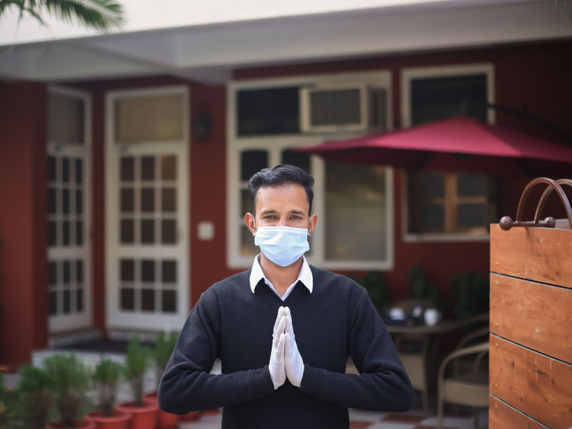 A butler greeting the viewer - Lamrin Boutique Cottages Rishikesh