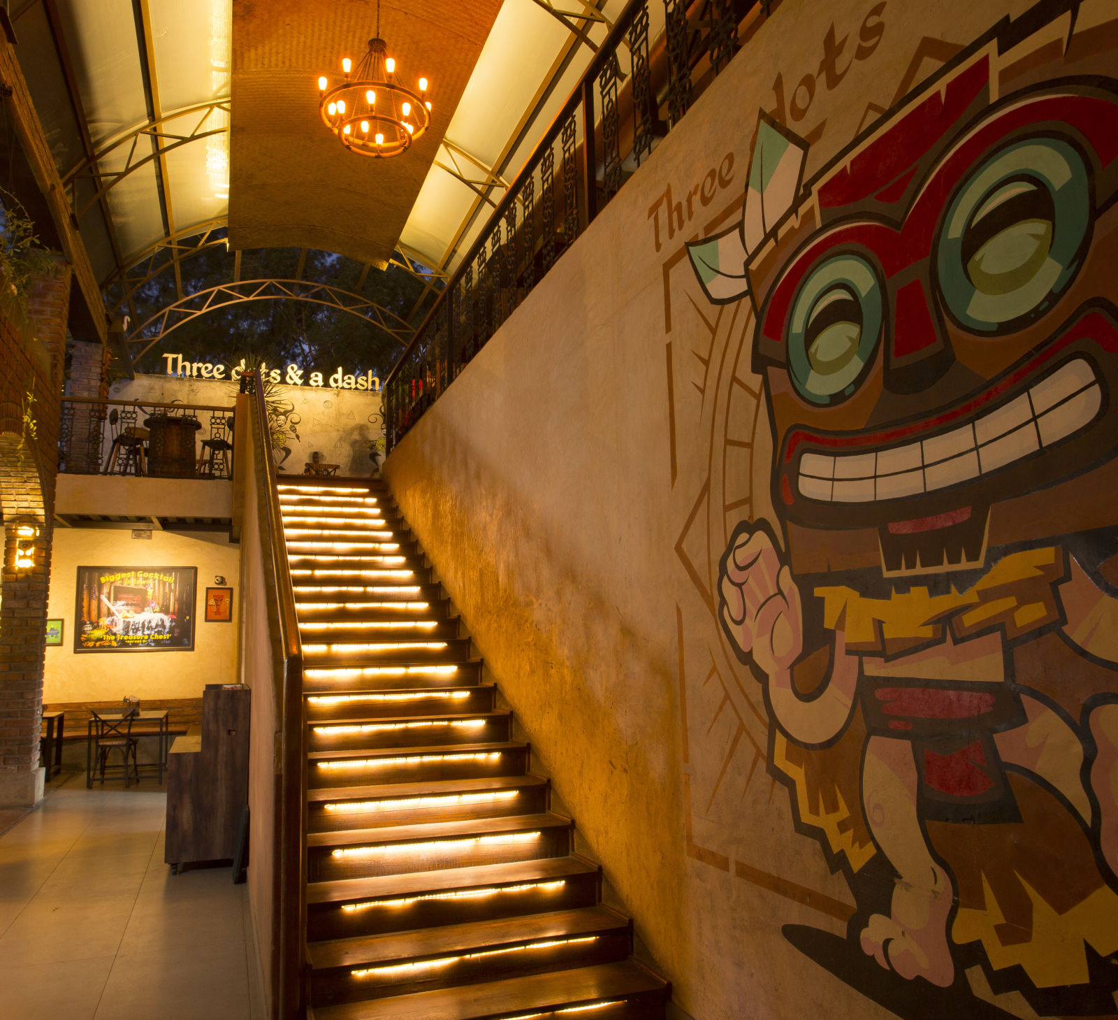 a staircase leading upstairs with graffiti on the wall beside the staircase - Hotel Fountain Tree By TGI - JP Nagar, Bangalore