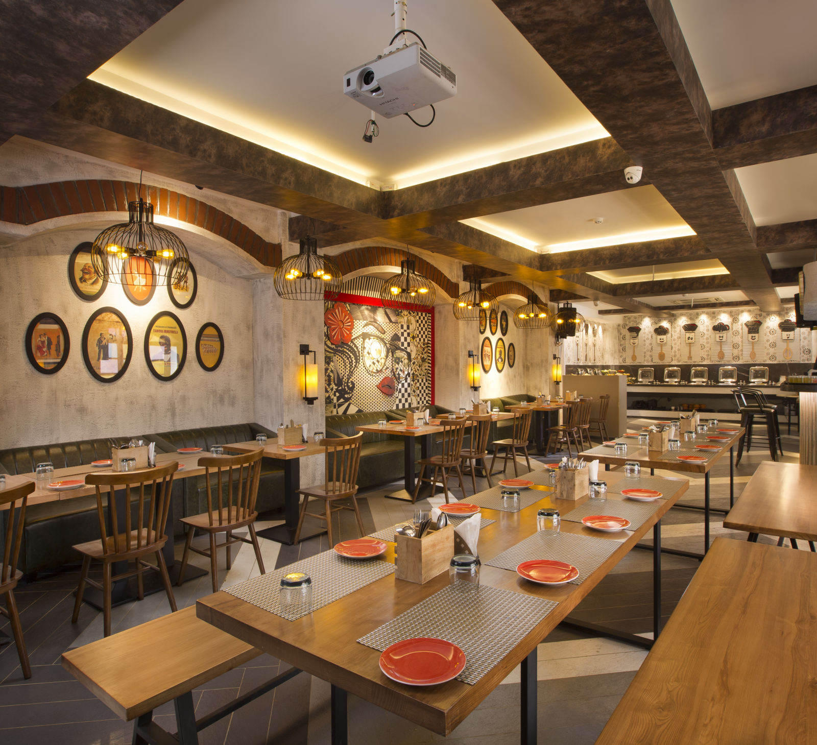 A cosy restaurant interior with wooden tables, pendant lighting and a buffet area in the background - Hotel Southend by TGI - Bommasandra, Bangalore