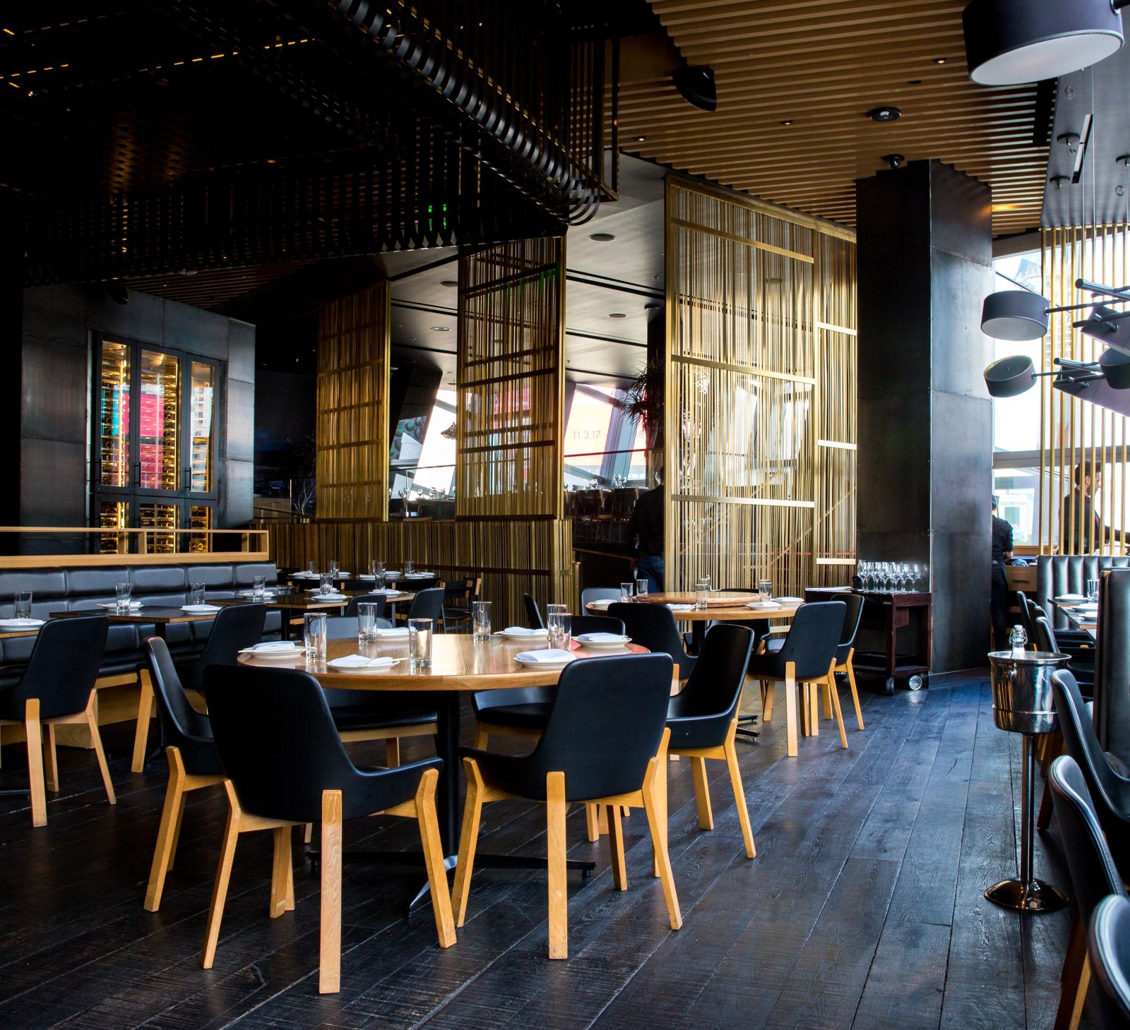 Seating arrangements inside a restaurant with the sun light shining through the windows