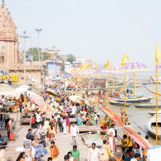 a wide angle shot of the ghats of Prayagraj filled with visitors and locals