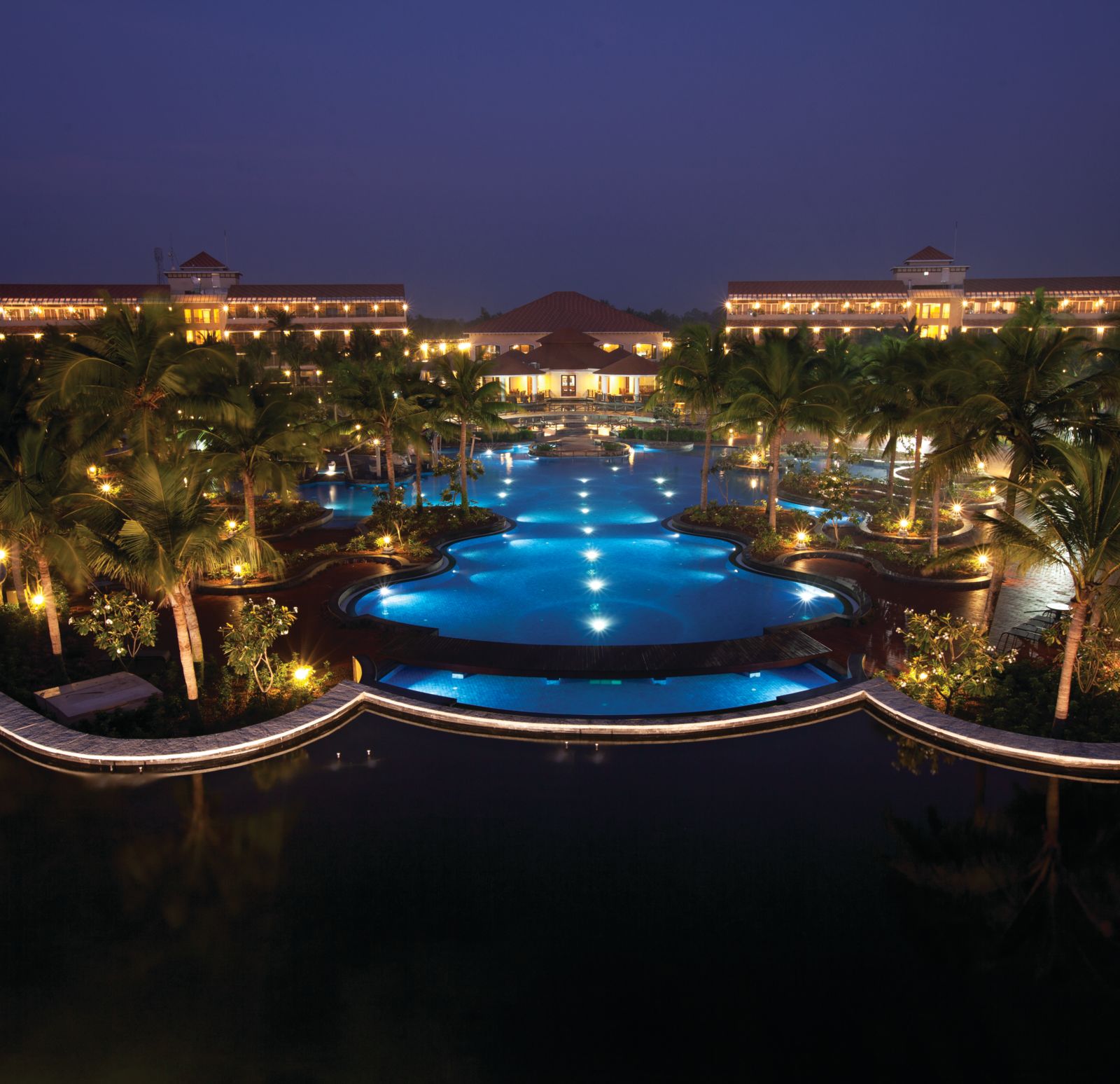 Wide angle Night View of the swimming pool and facade at Ocean Spray, Pondicherry