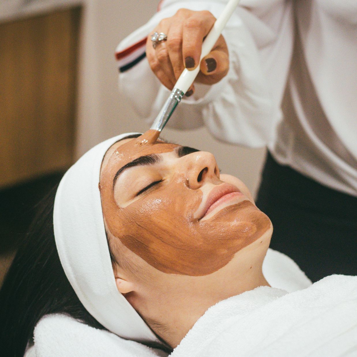 A woman receives facial therapy