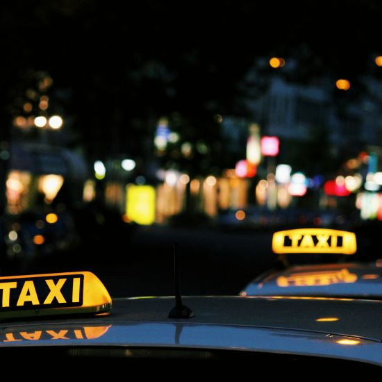 A shot of lit signs on the taxis at night