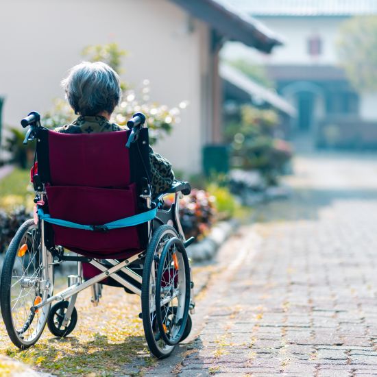 A back view of a person sitting on the wheel chair