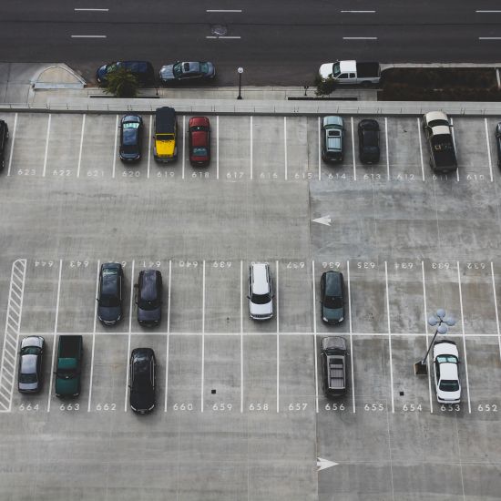 A head shot of cars parked in an outdoor parking lot