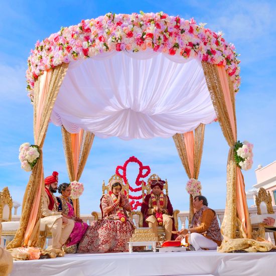 a wedding ceremony conducted with the bride and groom sitting in the centre - polo floatel kolkata