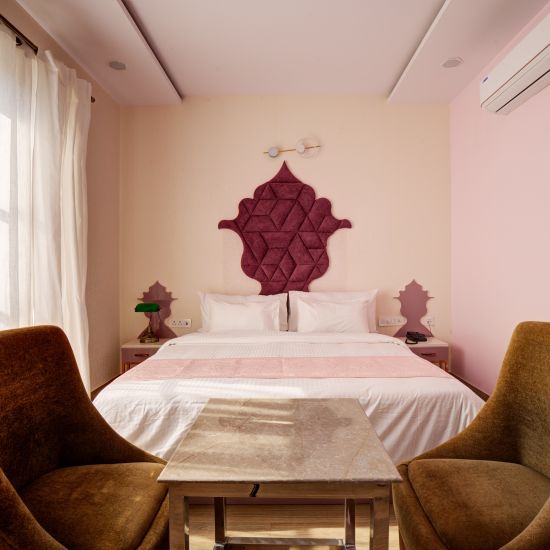 Pink themed Super Deluxe Room with chairs - The White Moon