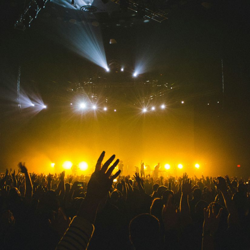 Concert with Yellow lights flashing from the stage