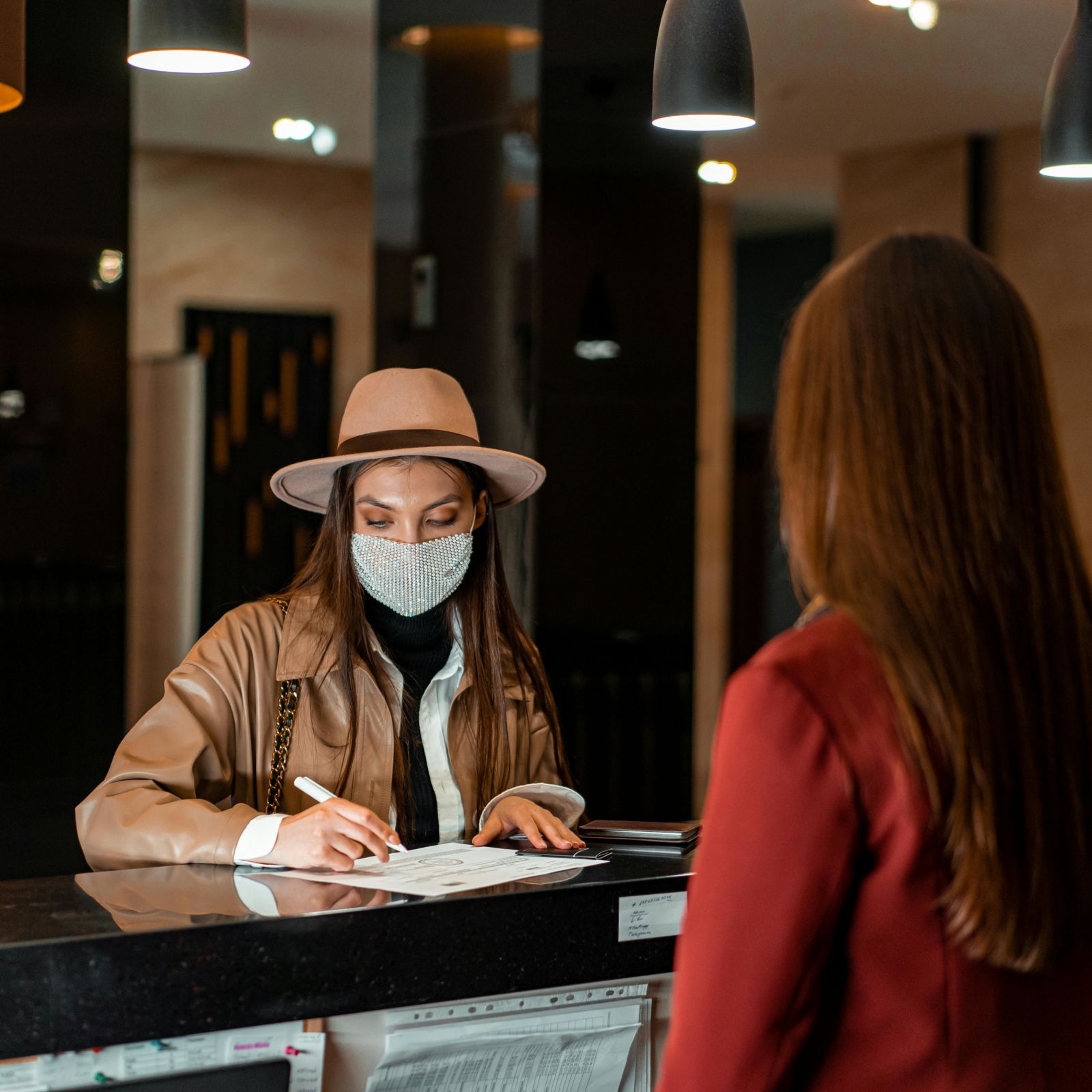 A women filling the form on travel desk