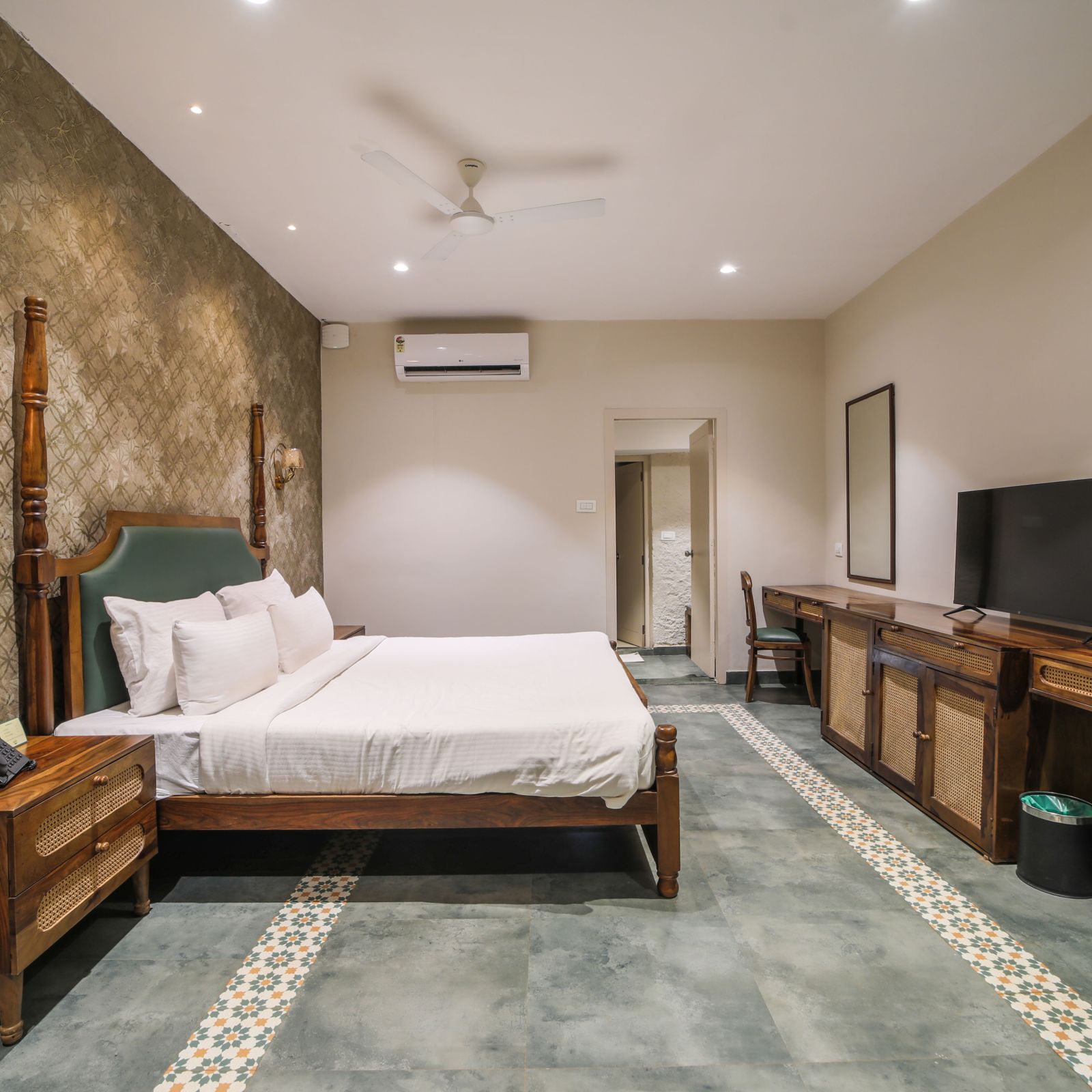 An image of a room with king size bed, TV, bed side table - Trance Veechika Resort, Vikarabad