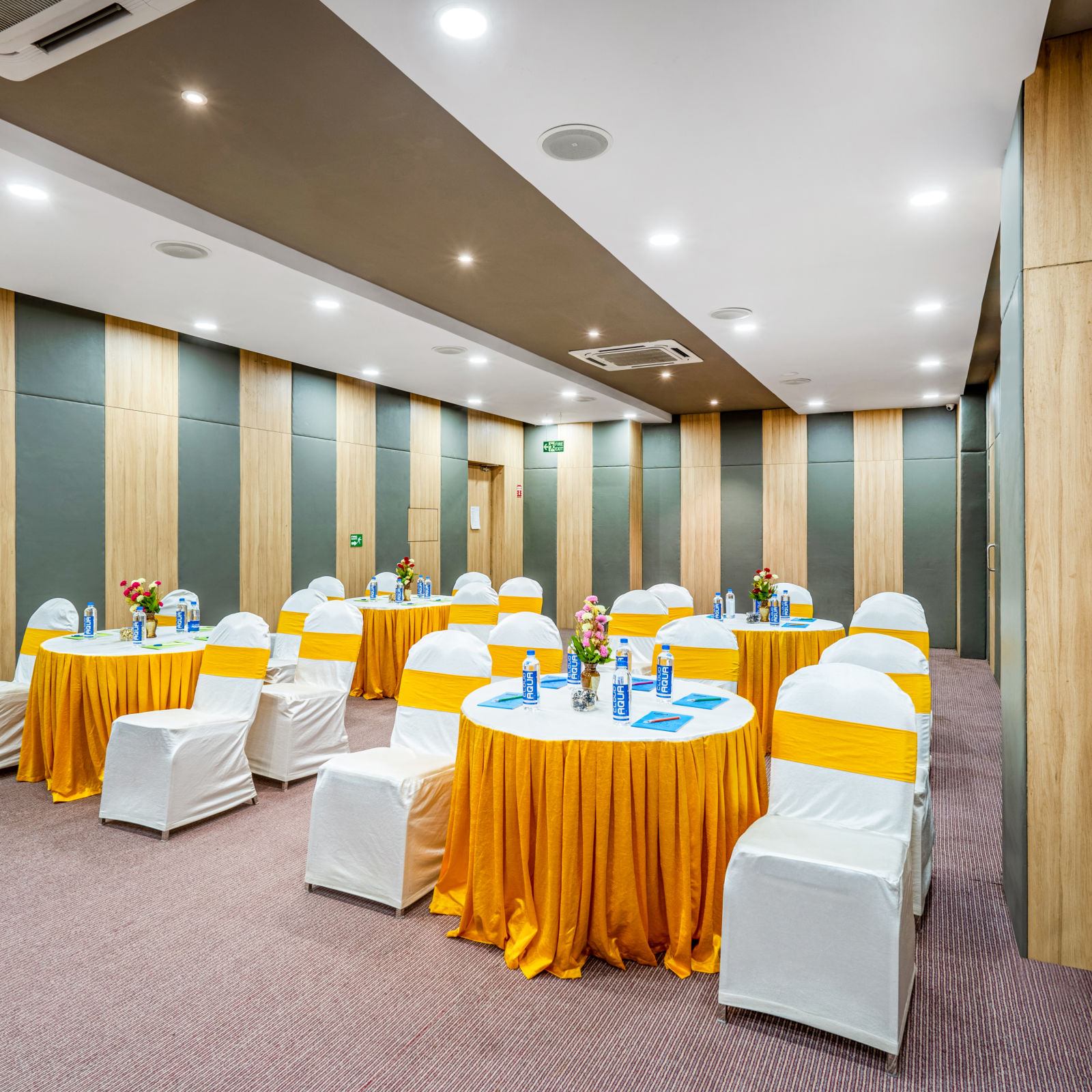 A well-furnished conference room displaying a table and chair at Westside Hotel