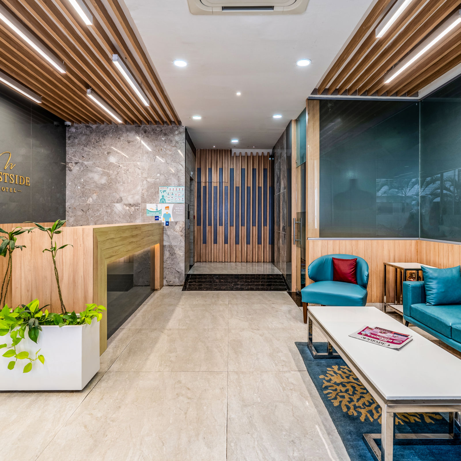 Contemporary lobby area at West Side Hotel with a well-appointed reception counter and stylish seating arrangement for visitors.