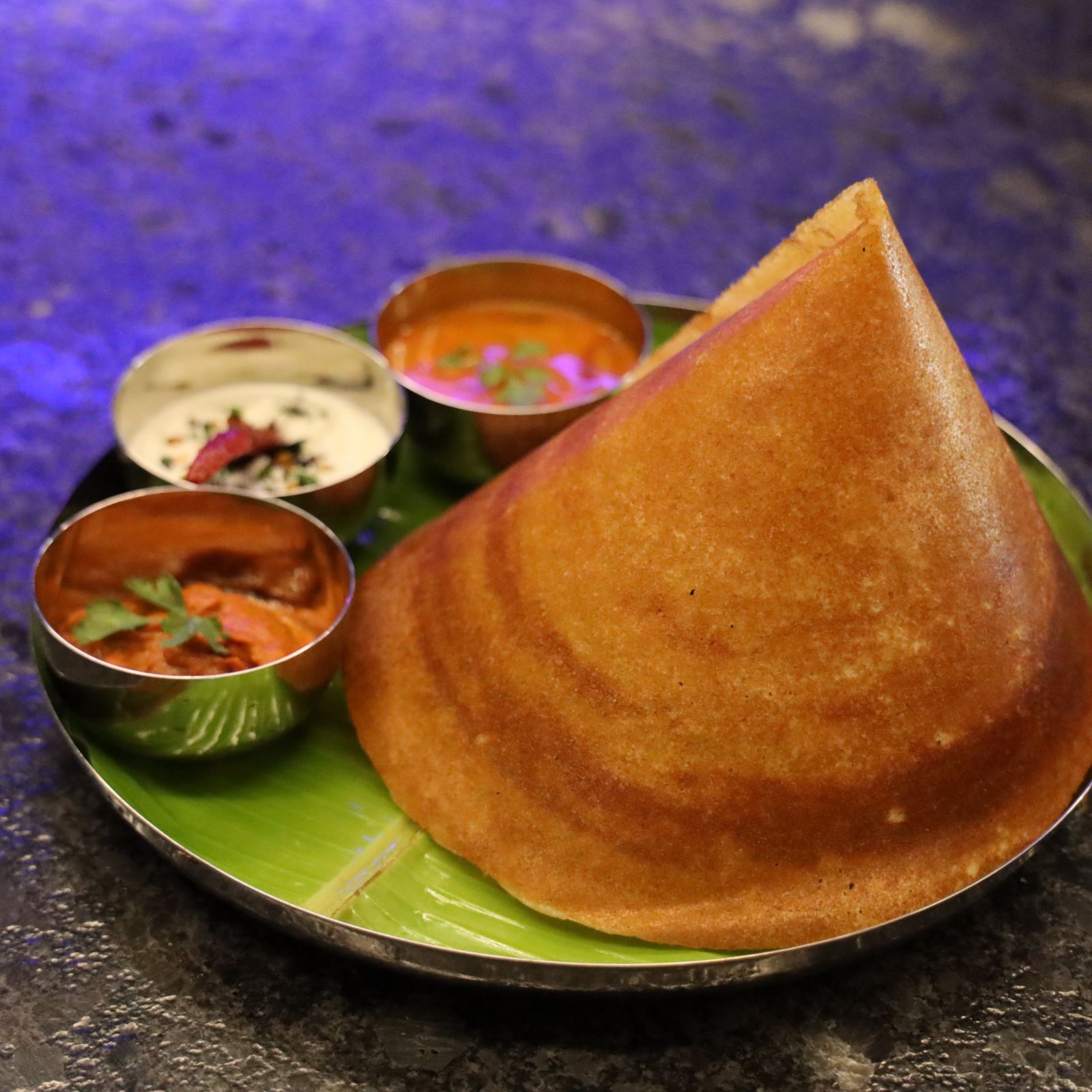 A plated dosa with chutney and sanmbhar in side bowls - Wonderla Bhubaneswar