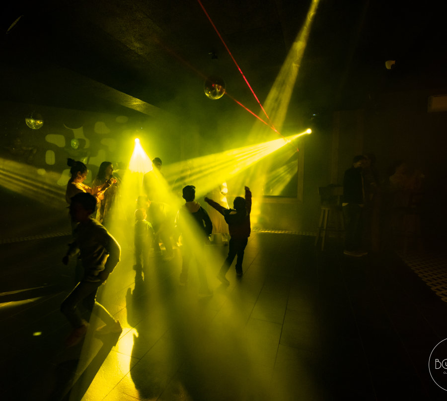 alt-text Yellow laser lights on party hall in The Bourbon Club N Lounge at The Tattva Boutique Resort, Joshimath