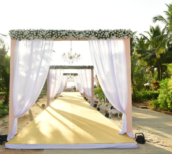 alt-text Wedding aisle decorated with flowers for your destination wedding venue in goa