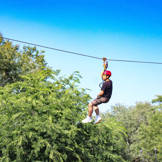 a person ziplining during daytime