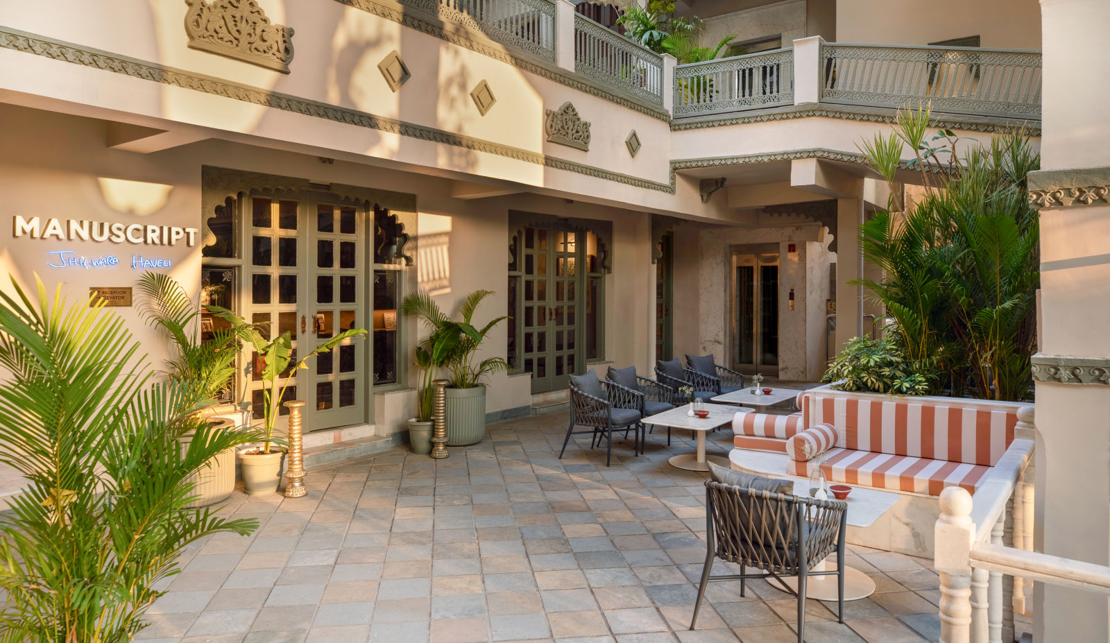 An overview of a courtyard with the inside of the building in view - Manuscript - Jhilwara Haveli, Udiapur