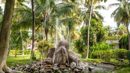 a fountain with coconut trees surrounding it - Black Thunder, Coimbatore