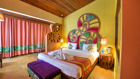 double bed and well-decorated interiors of one of the rooms at Sea Princess Beach Resort, Port Blair