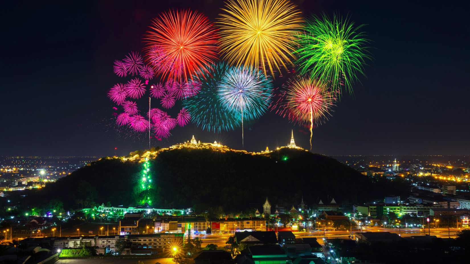 Colourful firecrackers bursting on the top of magnificent mountains