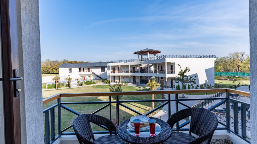 Balcony of the Deluxe Garden View Room with chairs and a coffee table 