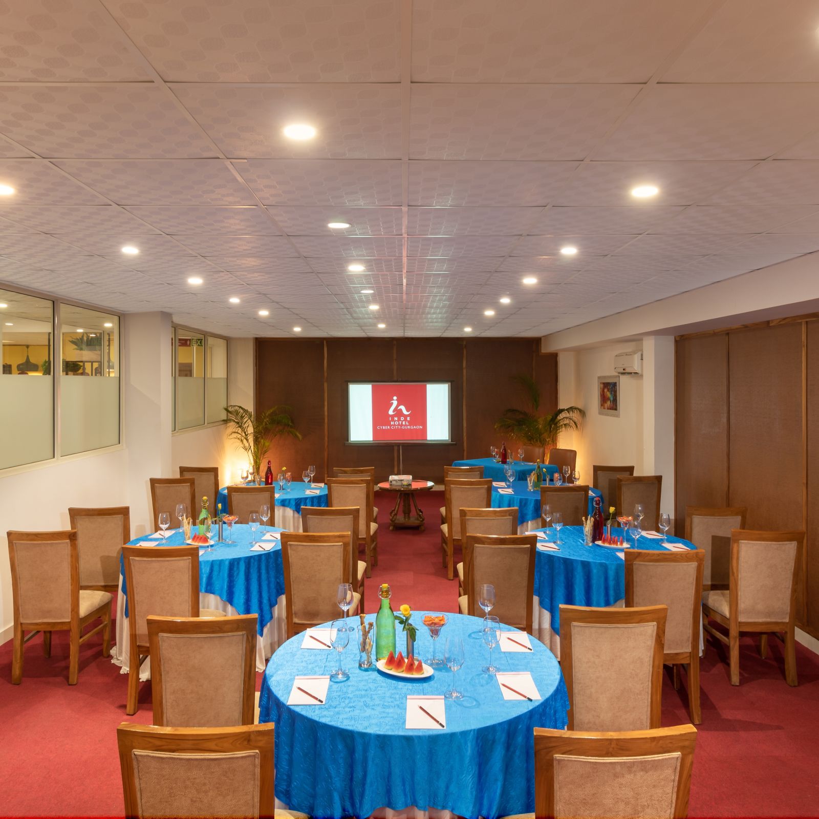 Senate Conference Hall with cluster seating arrangement, blue tables and chairs  | Inde Hotel Cyber City