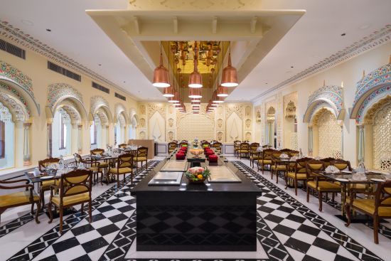 alt-text An image of the Suvarna Mahal with tables and a center piece - heritage village resorts & spa, Manesar